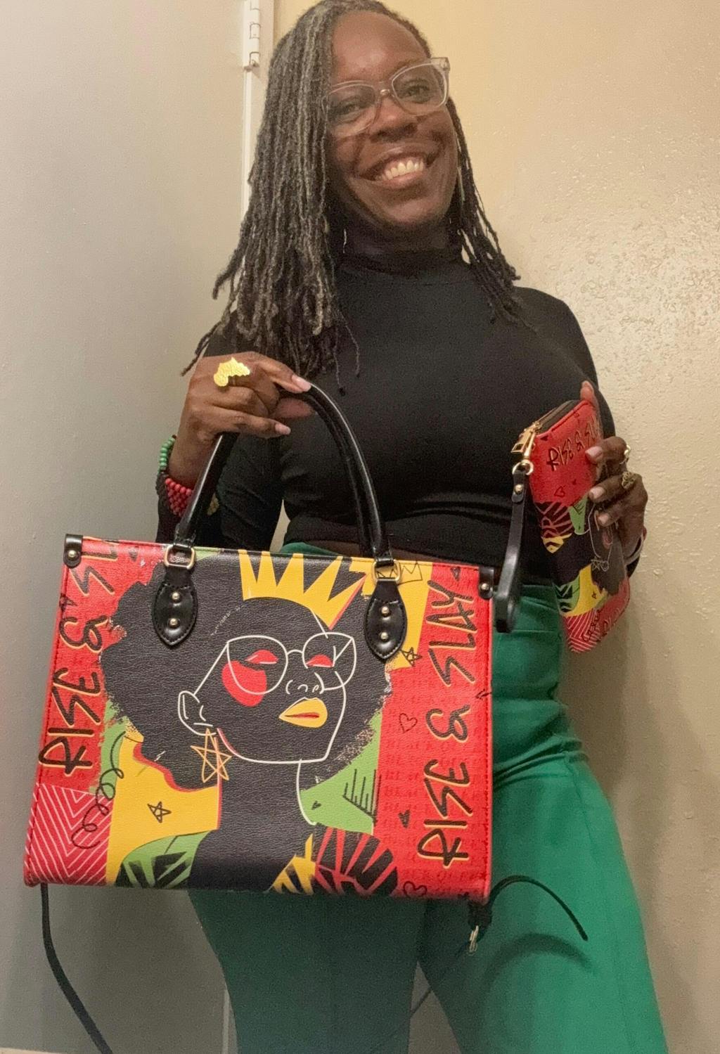 Person smiling, holding colorful bag with illustrated portrait and text.