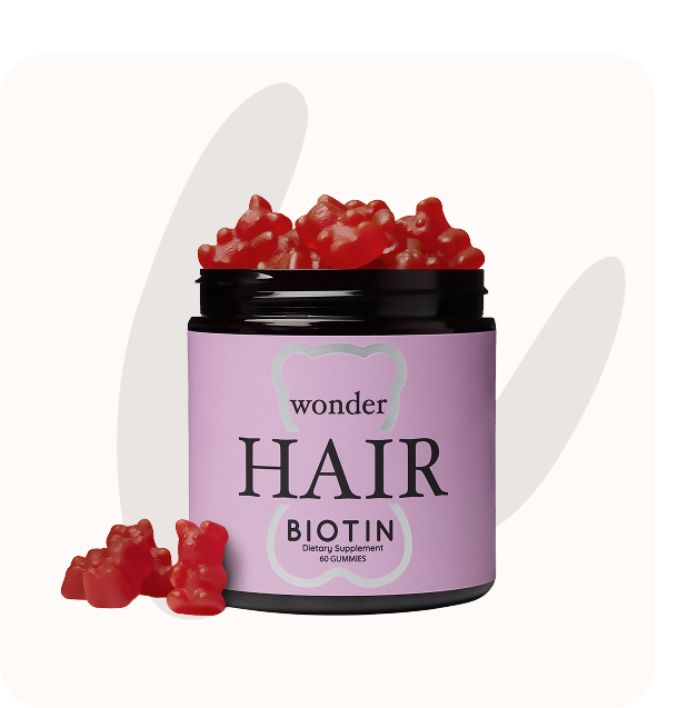 Jar of red gummy bears labeled 'Wonder Hair Biotin Dietary Supplement.'