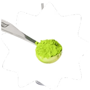 Spoonful of bright green powder on a white background.