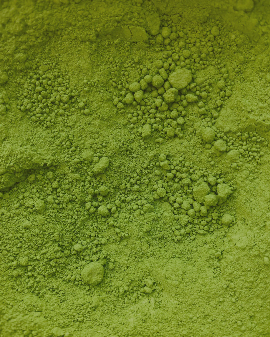 Close-up of textured green powder surface.