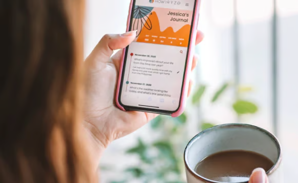 An over-the-shoulder view of a person holding a smartphone with a wellness app open on the screen.