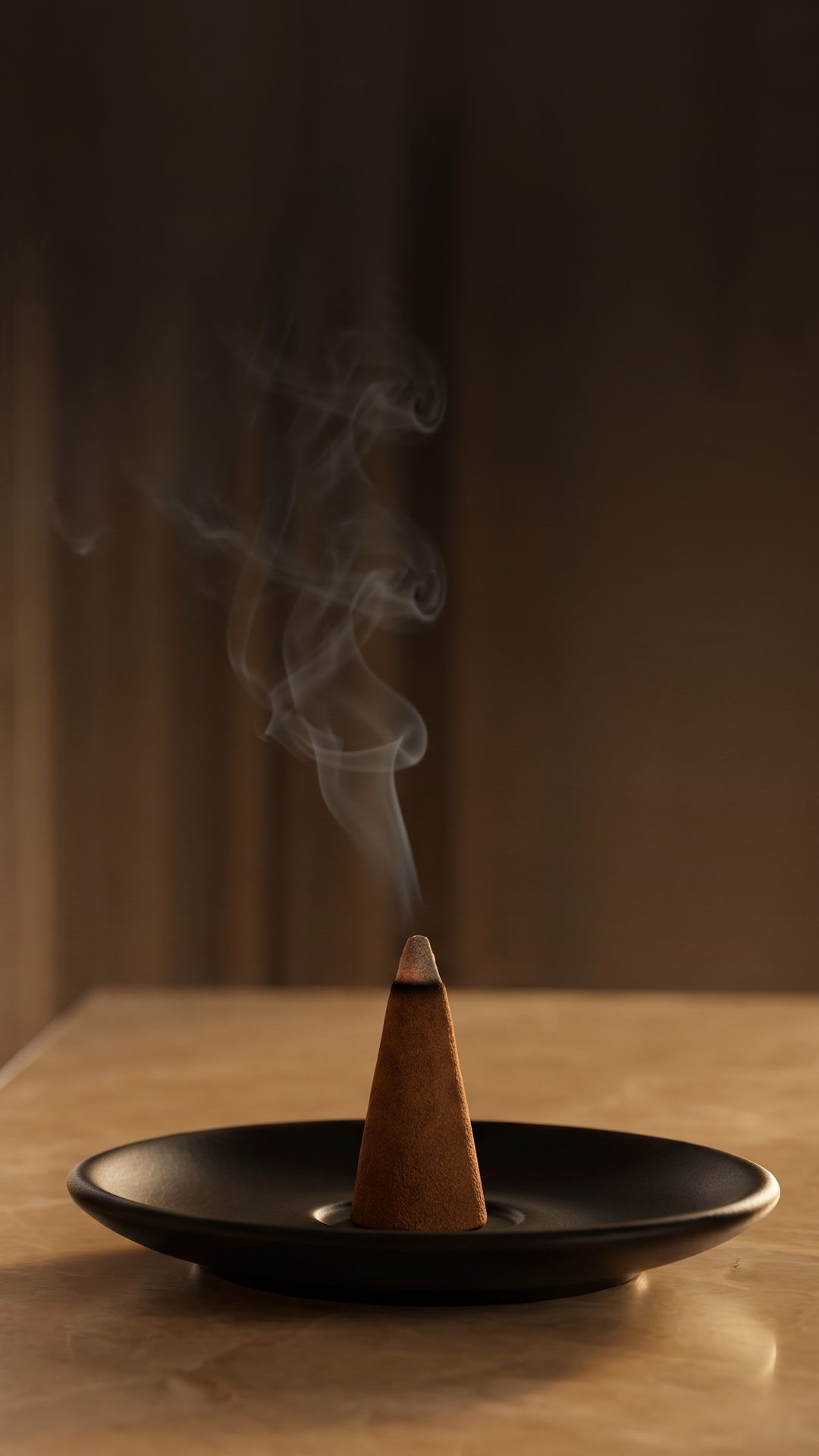 A cone of incense burns in a black dish, releasing a trail of smoke against a brown background.