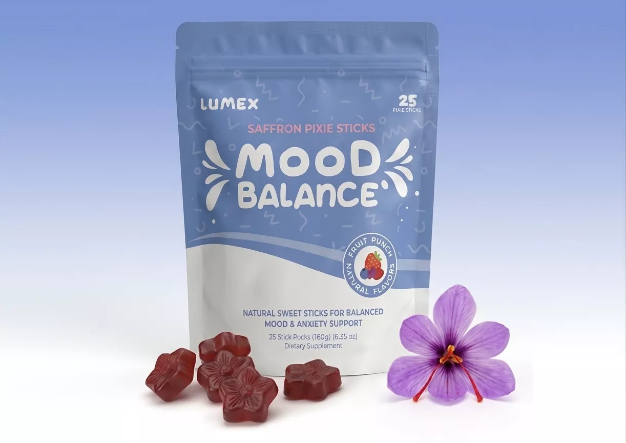 A pouch of Lumex Mood Balance supplement next to red, flower-shaped gummies and a purple saffron flower.