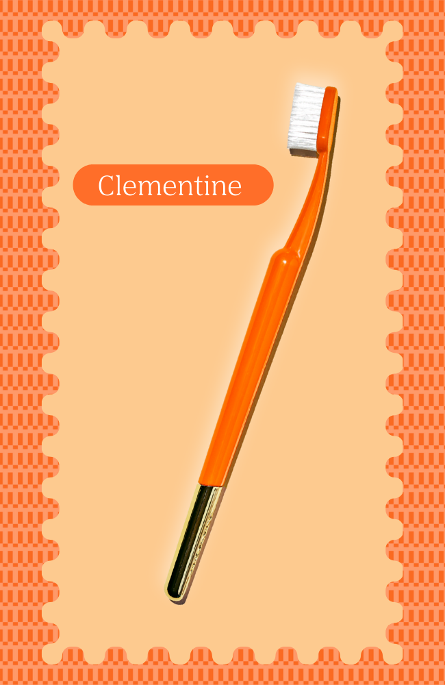 Orange toothbrush labeled 'Clementine' on a patterned background.