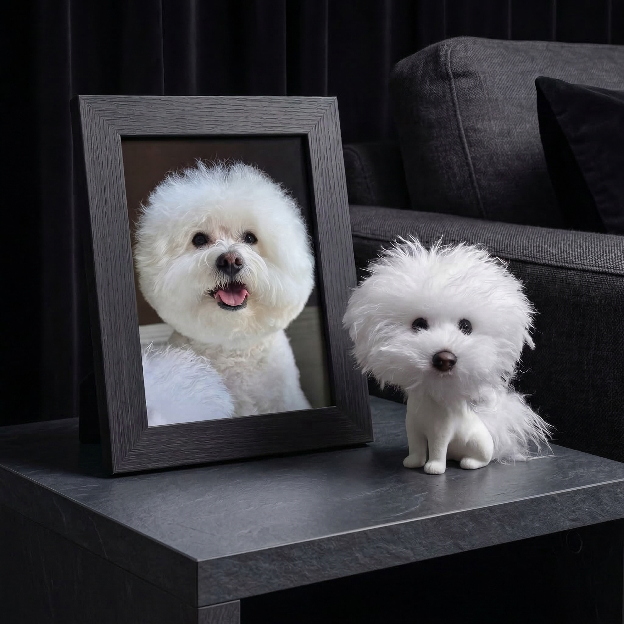 Framed Bichon Frisé photo beside a matching custom bobblehead on a wooden side table.