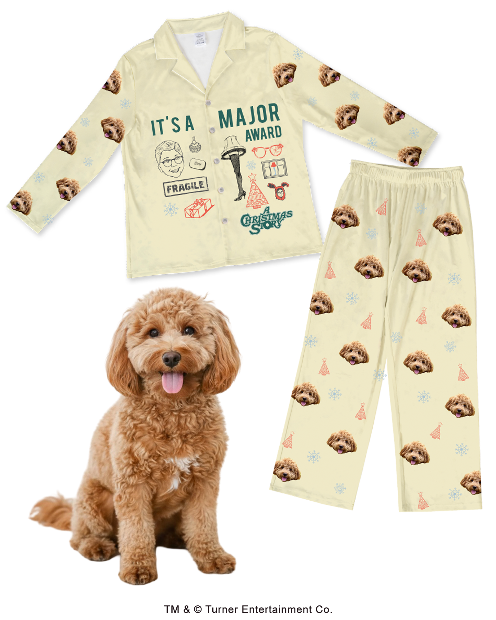 A beige pajama set (long-sleeve top and pants) featuring the theme of A Christmas Story. The top has graphics including the Leg Lamp, the word 'FRAGILE,' and the quote 'IT'S A MAJOR AWARD.' The entire set is patterned with a repeating design of a fluffy brown Cockapoo's face, small snowflakes, and Christmas tree cones. A real Cockapoo dog sits in the foreground.