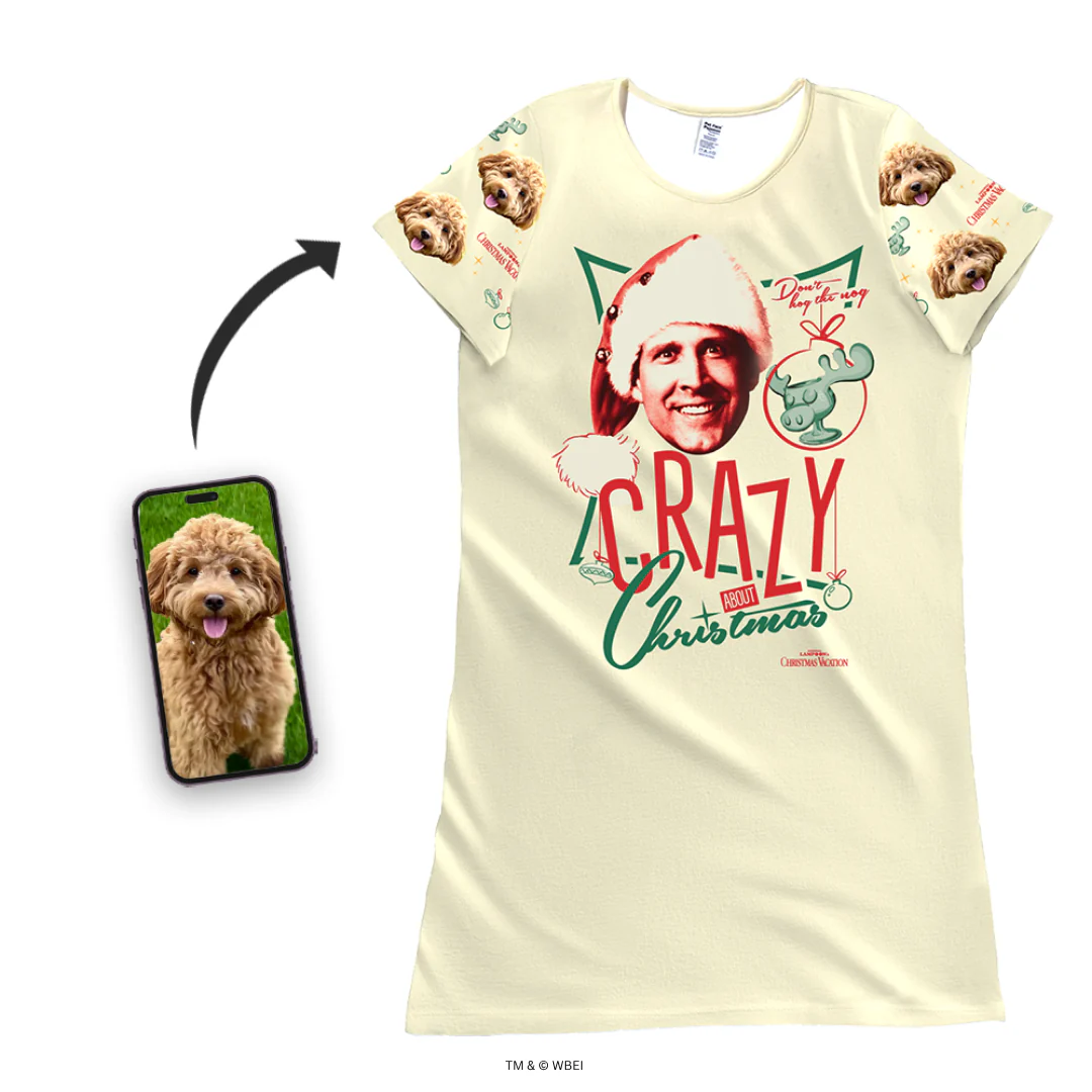 A short-sleeve, cream or beige nightgown features a large graphic of Clark Griswold's face in a Santa hat, a moose mug, and the text 'CRAZY about Christmas.' The sleeves are customized with a repeating design of a fluffy brown Cockapoo's face and small Christmas graphics. A smartphone screen inset shows the original photo of the Cockapoo, with an arrow pointing to the nightgown.