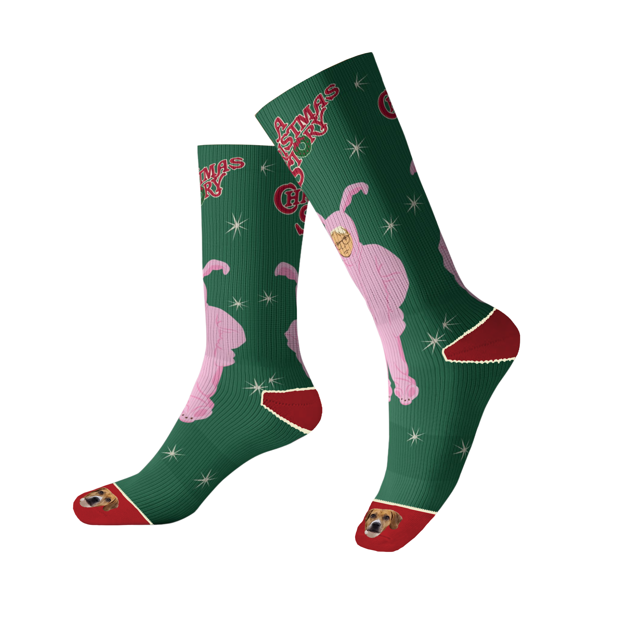 A pair of tall green socks with red trim on the cuff and heel, featuring a pink silhouette of Ralphie in the bunny suit and the movie title 'A Christmas Story.' The socks are patterned with white starbursts, and the toe of each sock features an image of a brown and white dog's face. The socks are shown on a black background.