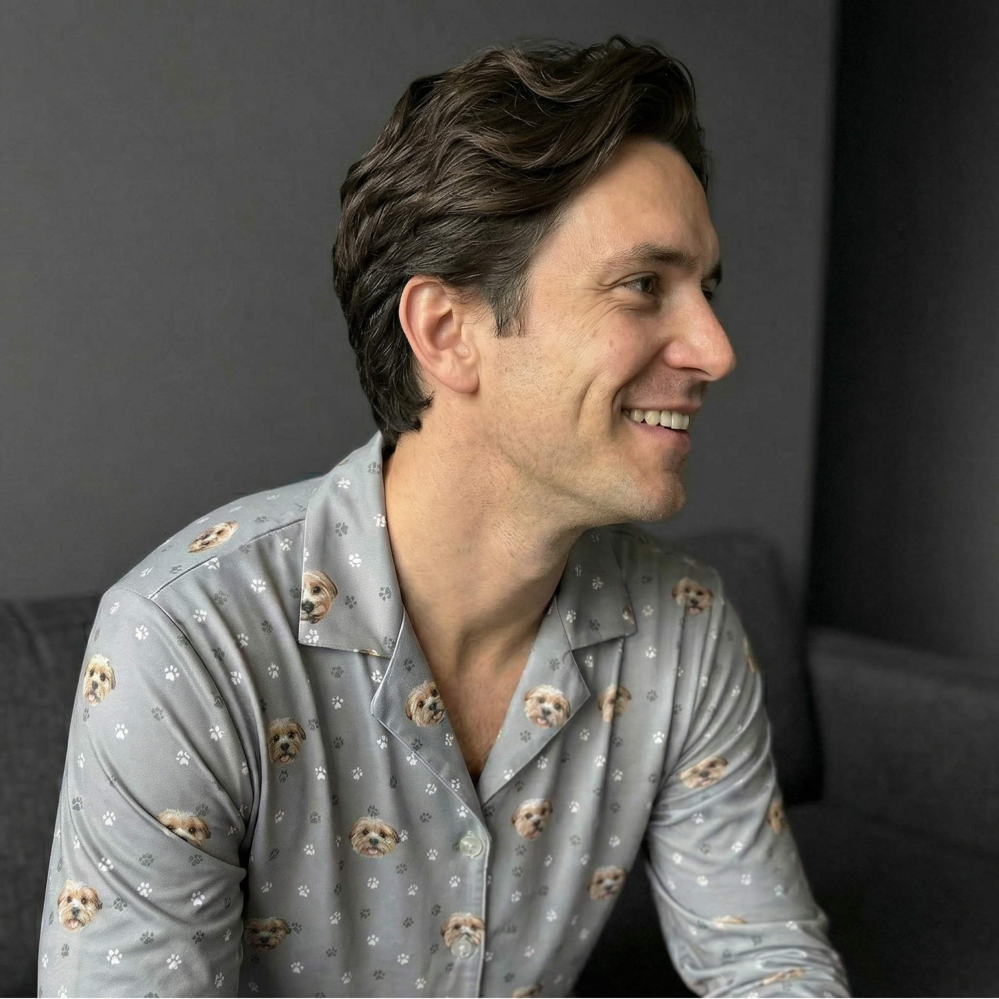 Close up of a man wearing a gray pajamas.