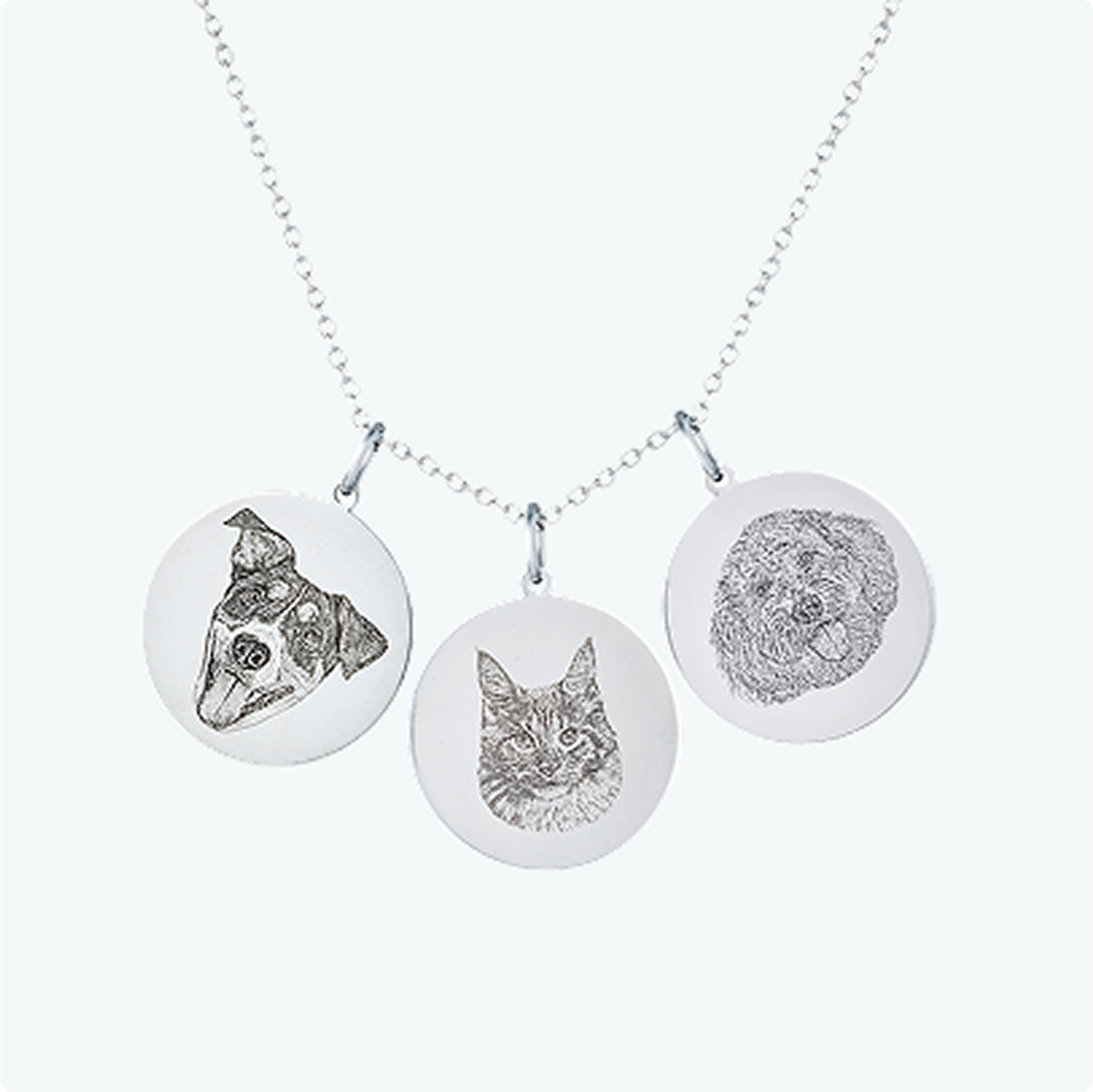 Necklace with three engraved animal portraits on circular pendants.