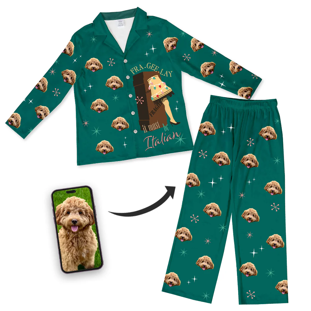 Promotional image for custom pet pajamas. A green pajama set (collared top and pants) features a graphic of the Leg Lamp inside a wooden crate and the quote 'FRA-GEE-LAY it must be Italian.' The set is patterned with starbursts and a repeating design of a fluffy brown Cockapoo's face. A smartphone screen inset shows the original photo of the Cockapoo, with an arrow pointing to the pajamas.