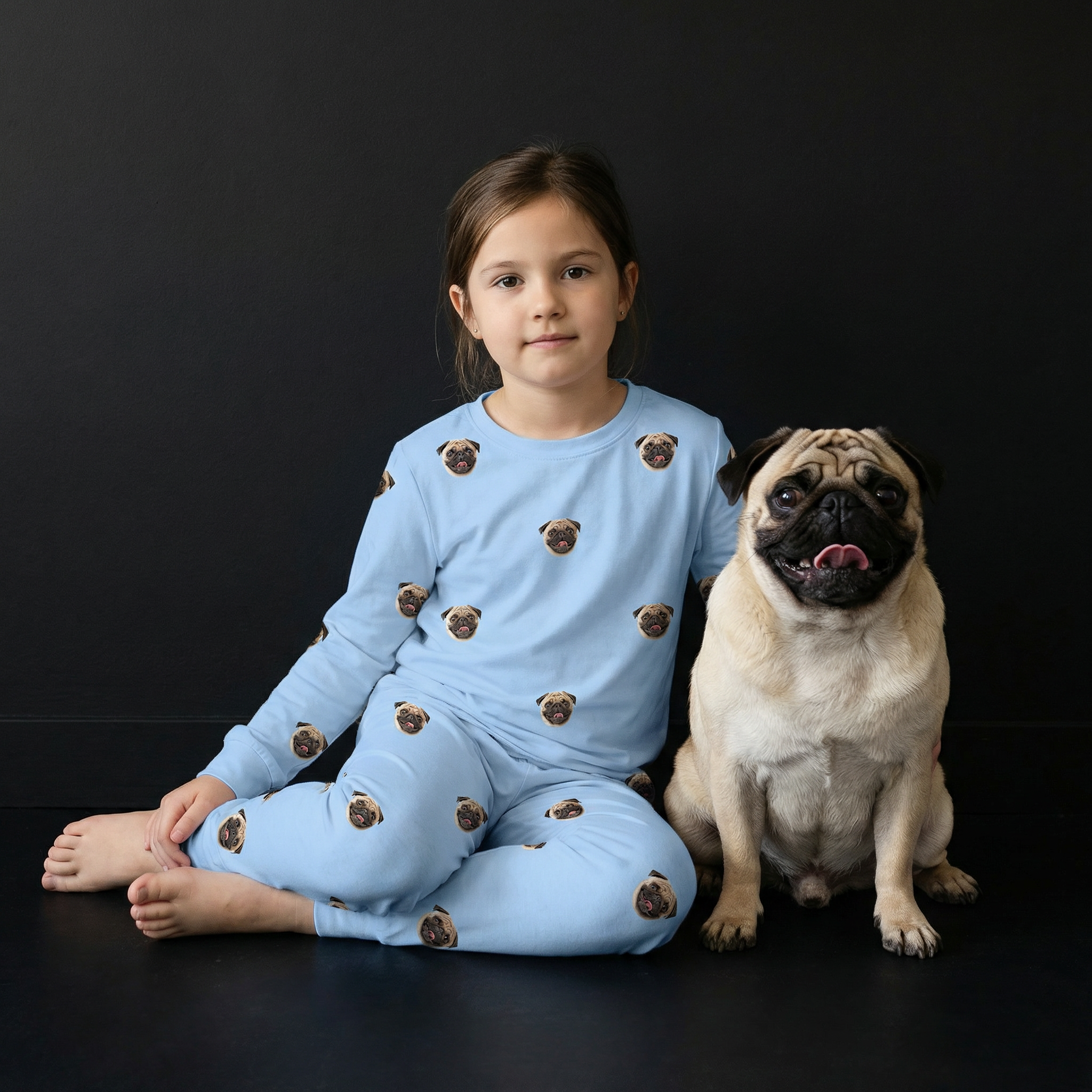 Girl with blue jogger pajamas with a dog.