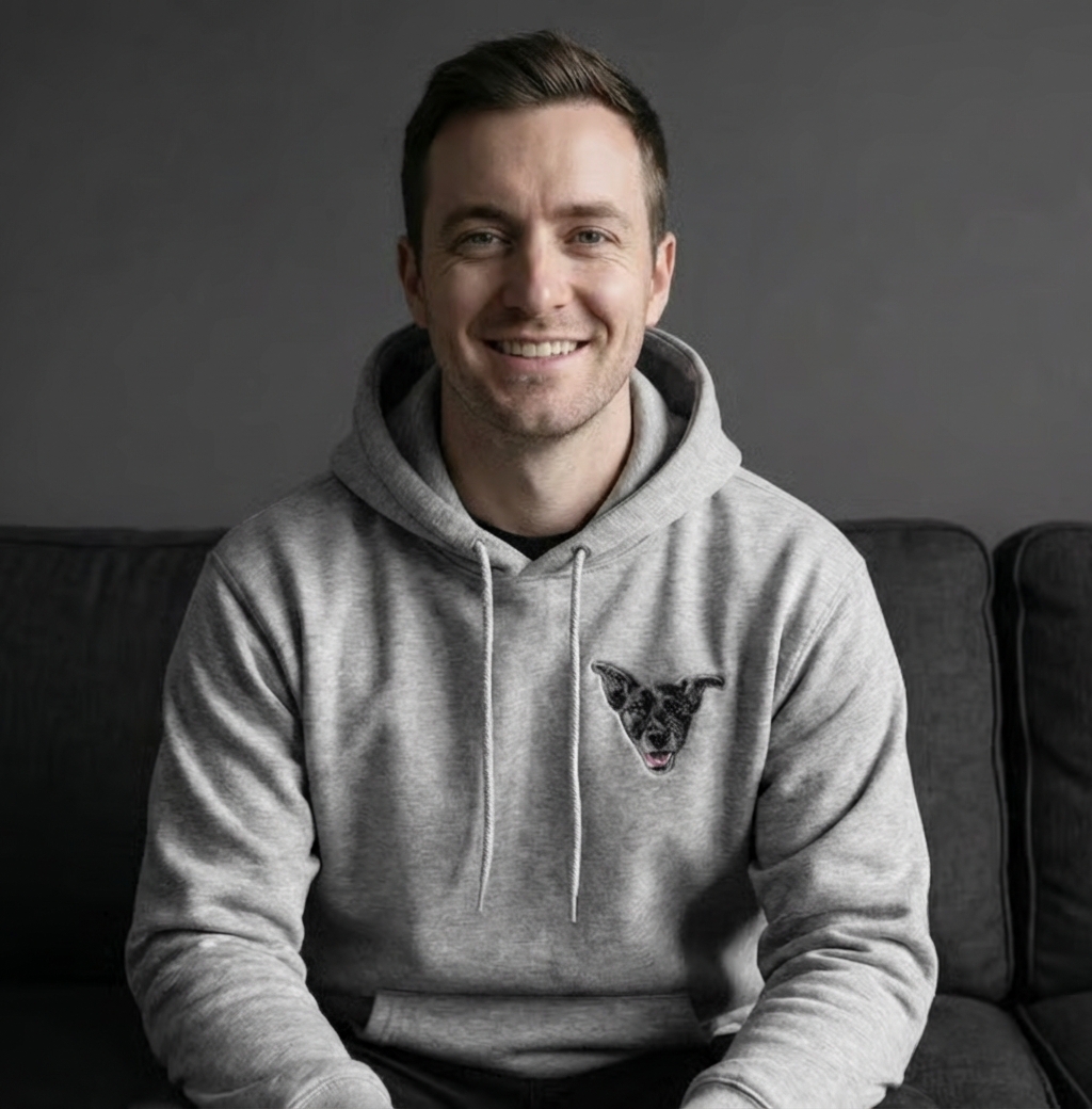 Person sitting on a couch wearing socks with dog faces.