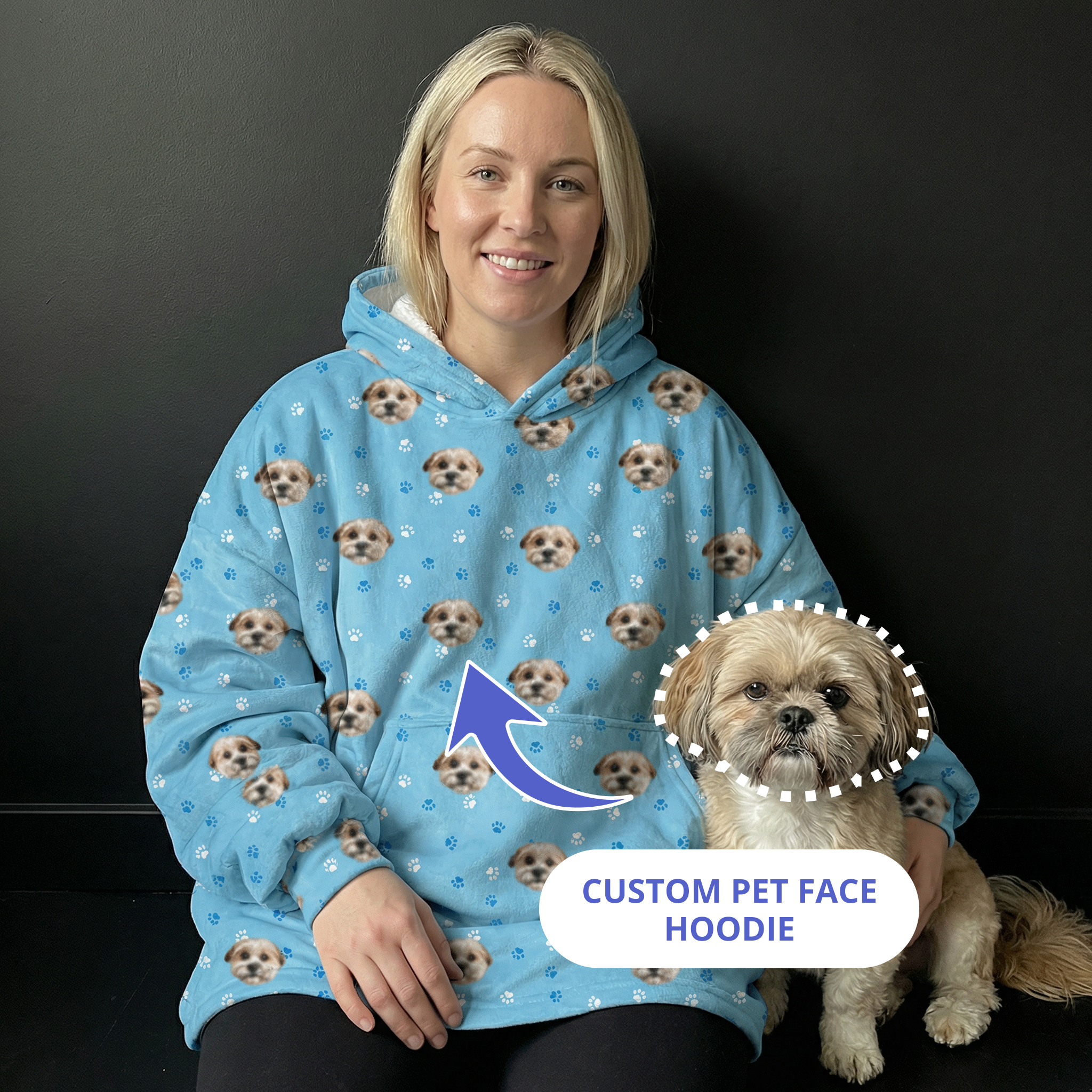 Woman wearing a blue hoodie next to her dog.