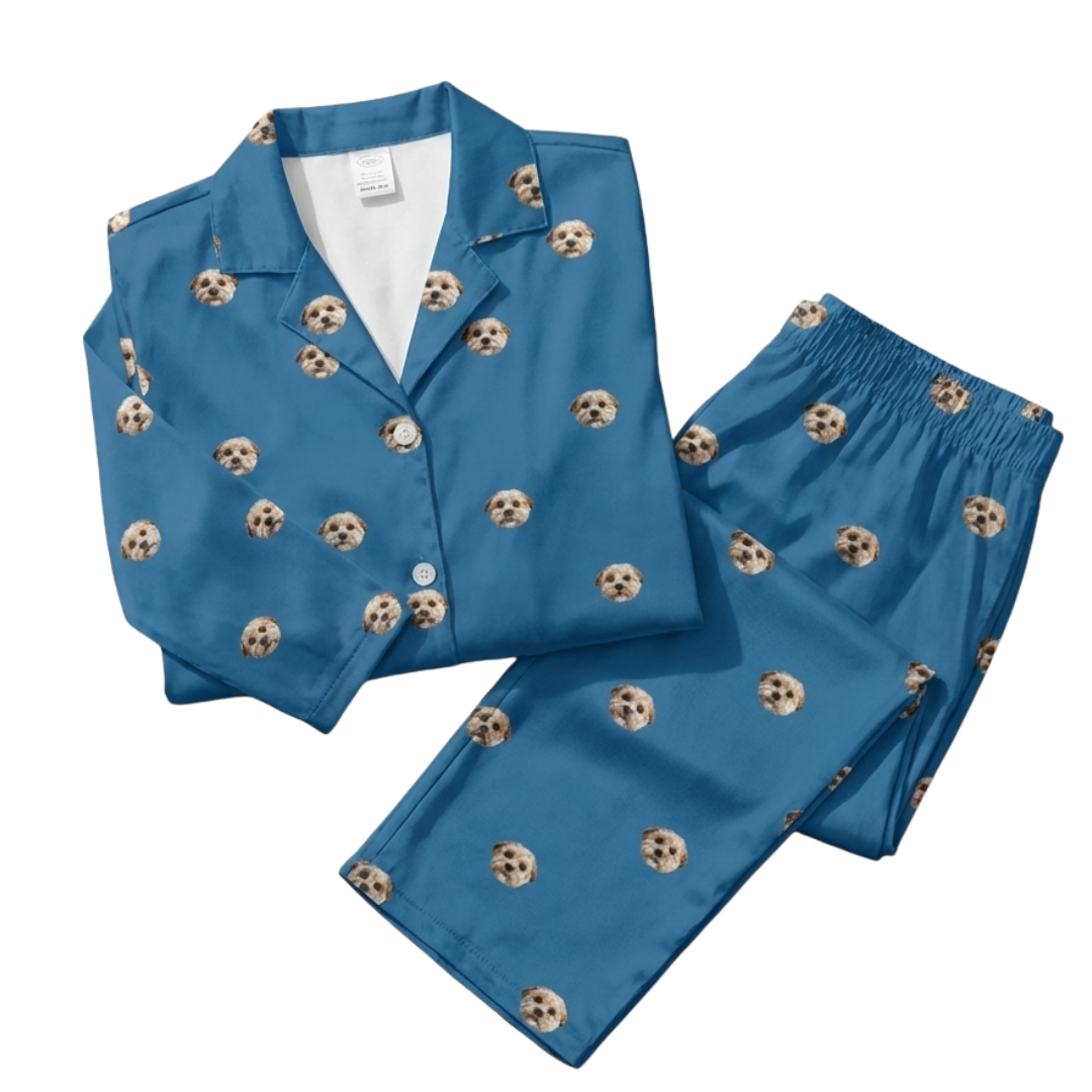 Blue pajamas with dog face pattern, laid out flat.