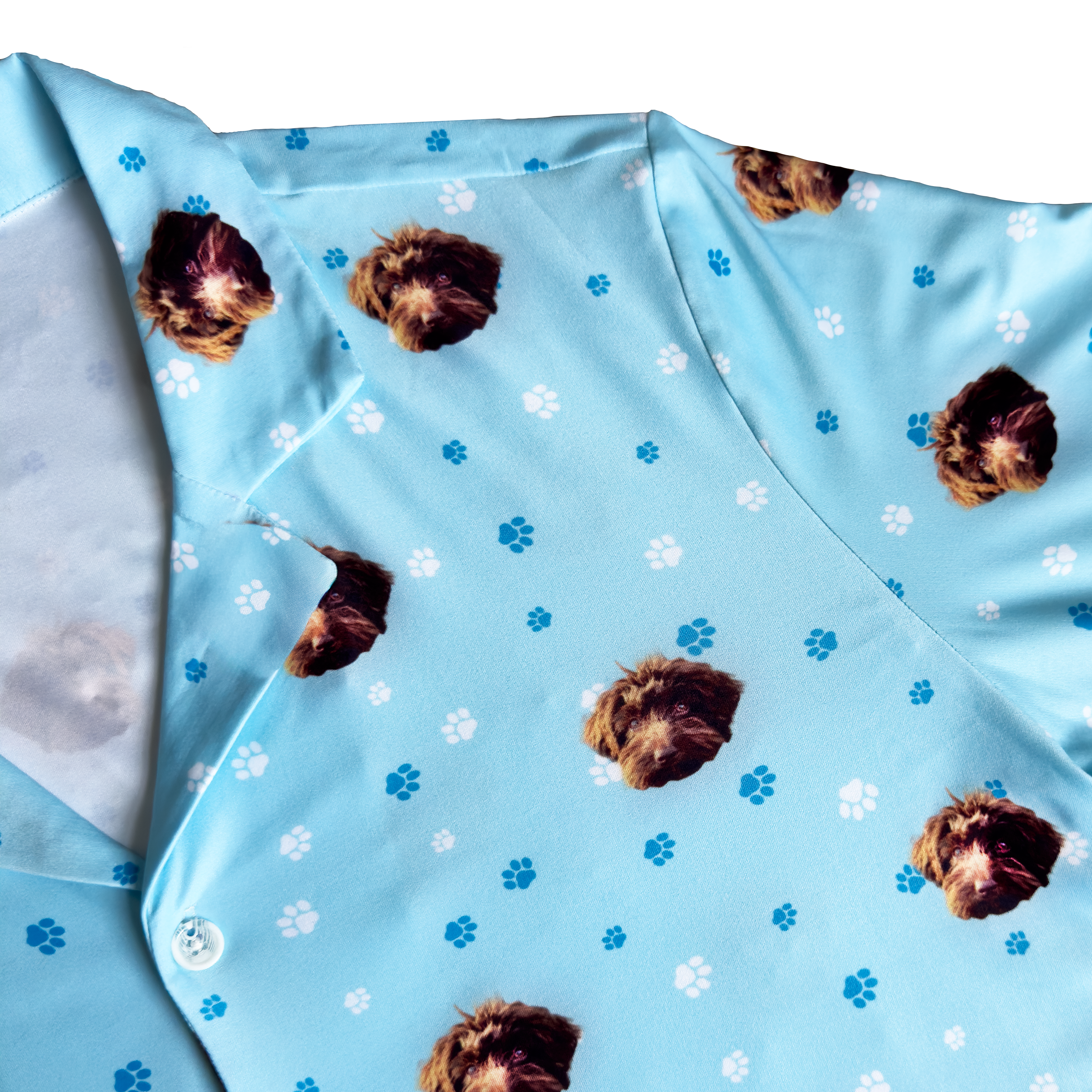Light blue shirt with dog face and paw prints pattern.