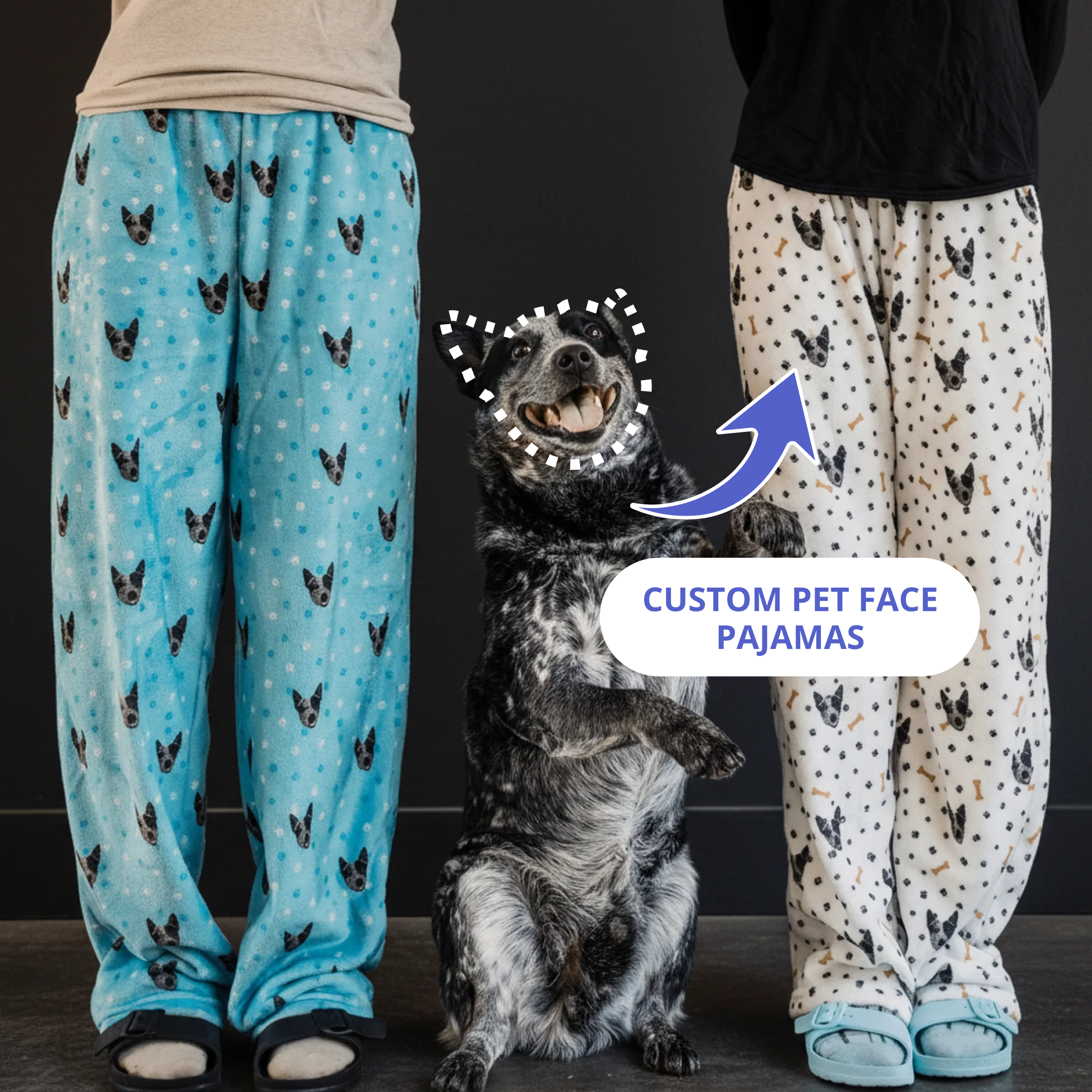 Happy Blue Heeler sitting between two people wearing pajama pants with the dog’s face