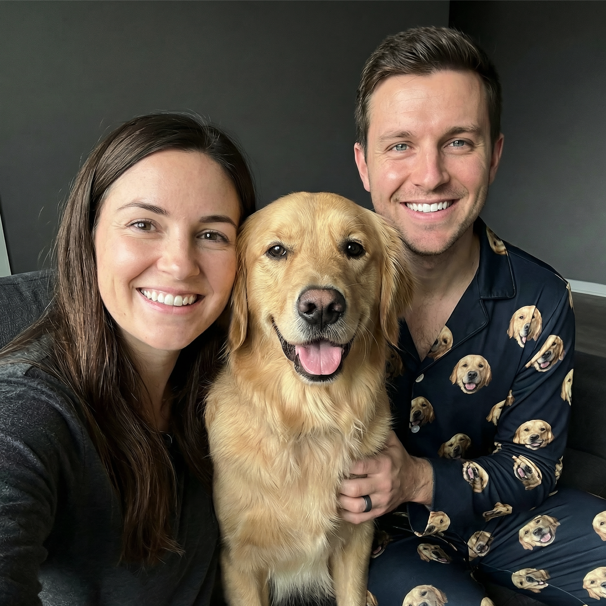 Couple with Golden Retriever, the man is wearing a pajama with dog faces.