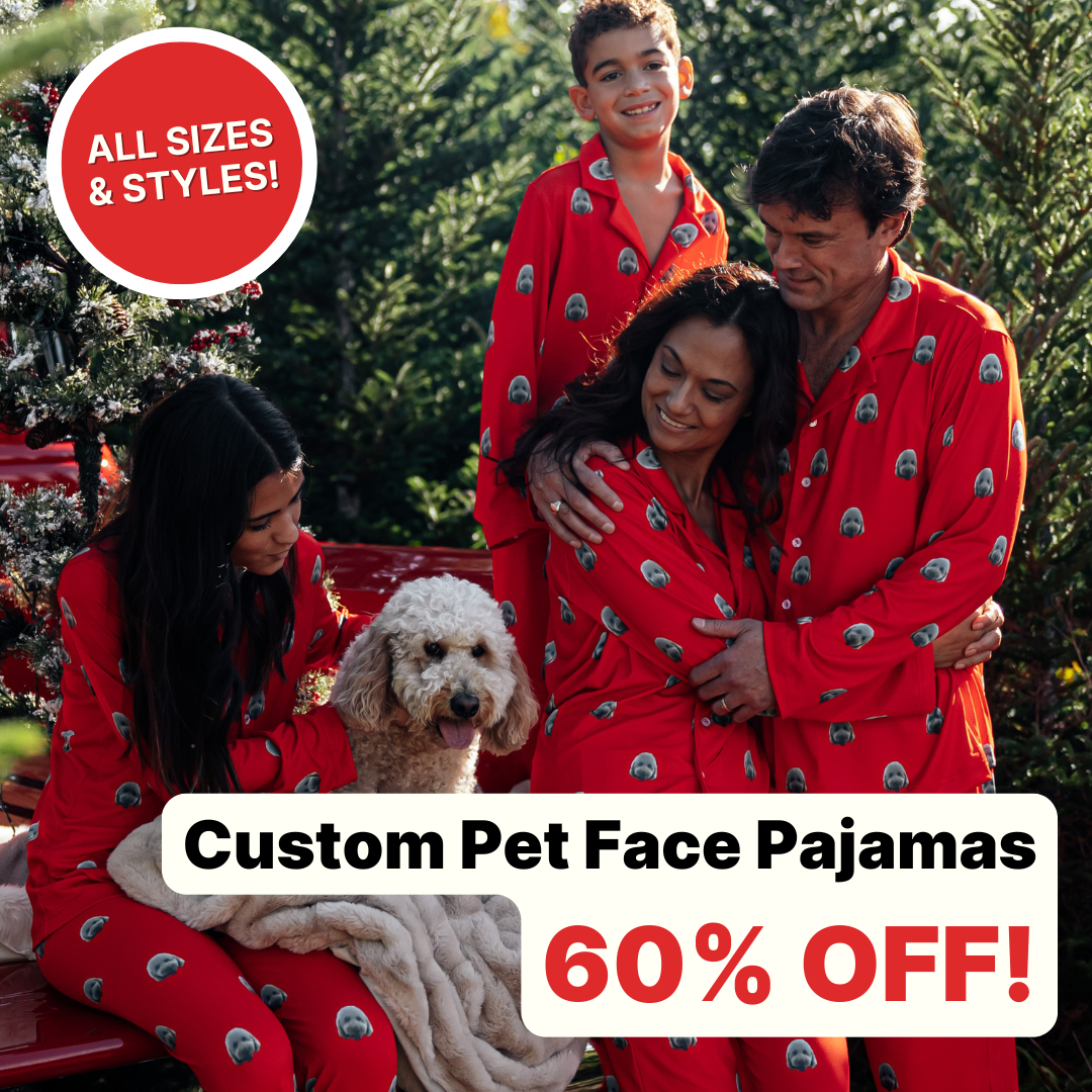 Family in red pajamas with a dog beside a Christmas tree.