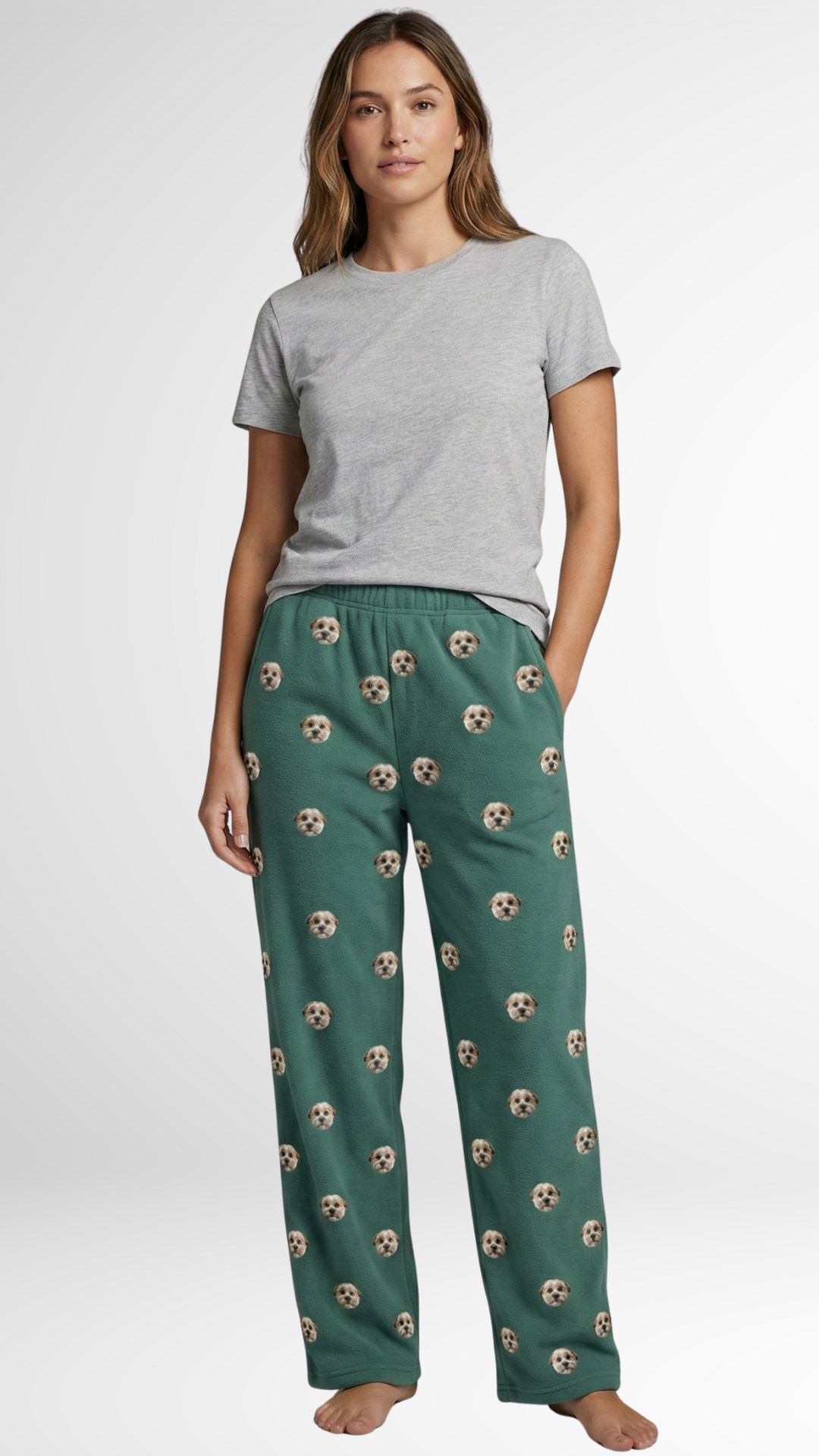 Woman in a gray tee and green pajama pants with custom dog face print.