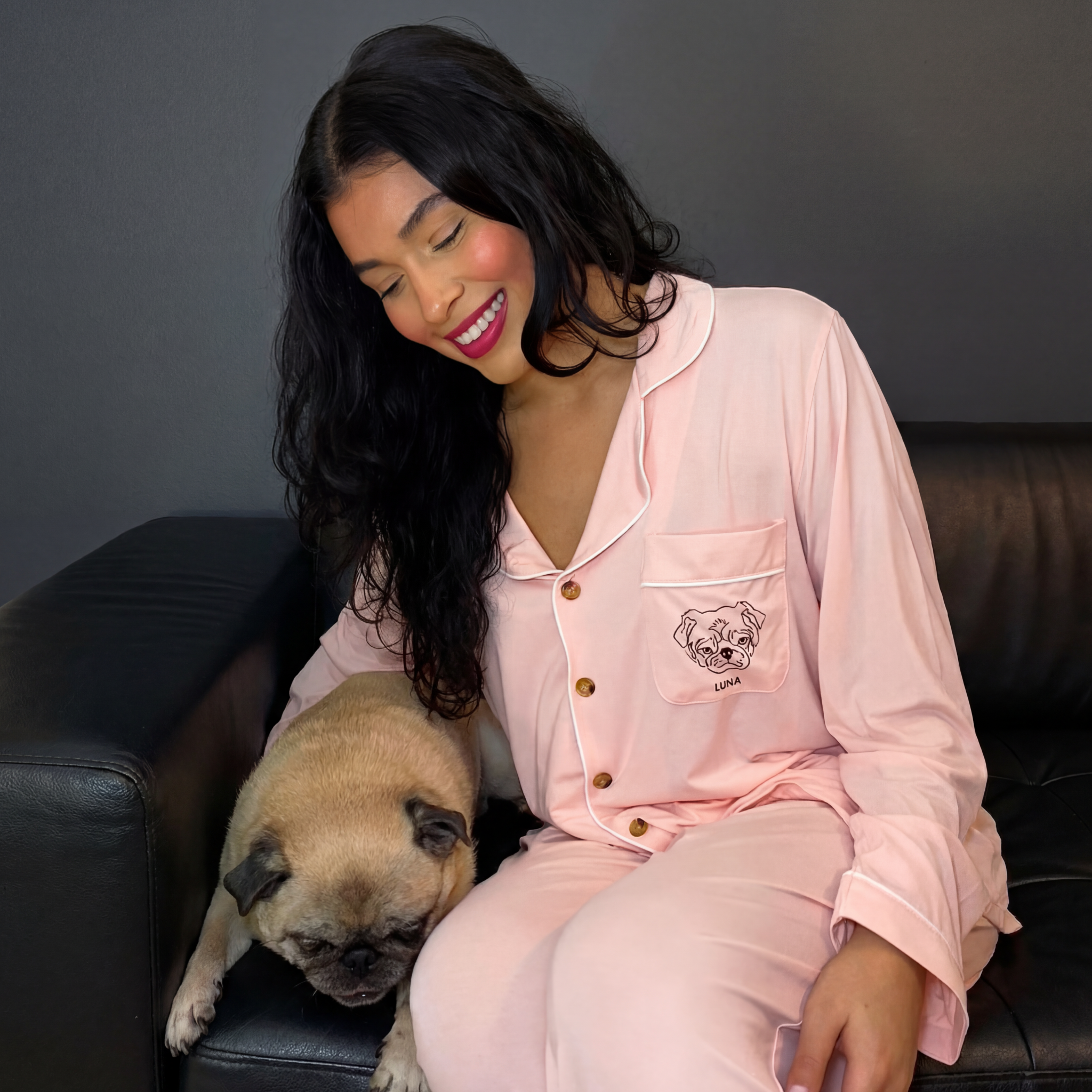Woman & Pug on couch, pink PJ set with custom 'LUNA' pug face embroidery