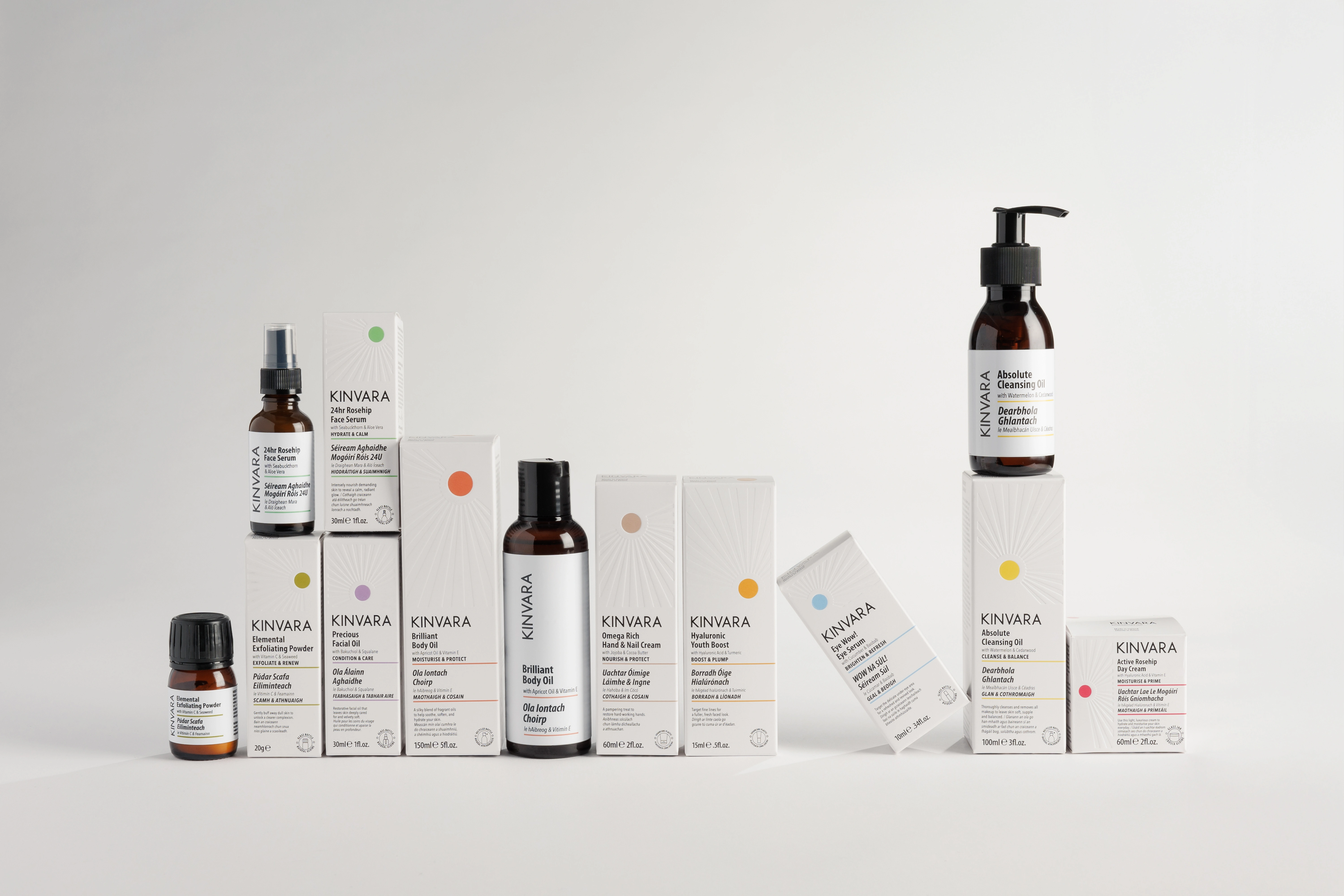 A collection of various KINVARA skincare products and their white boxes against a plain background.