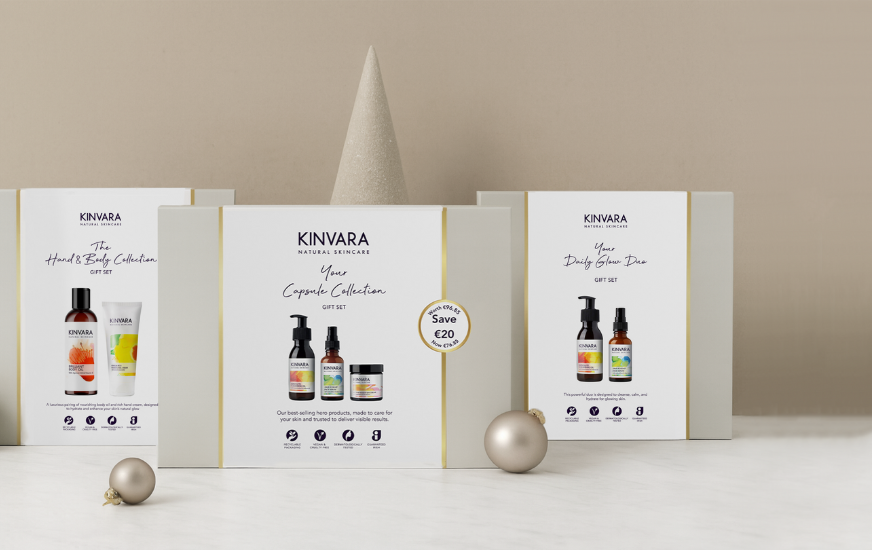 Three Kinvara skincare gift boxes with decorative cones and baubles.