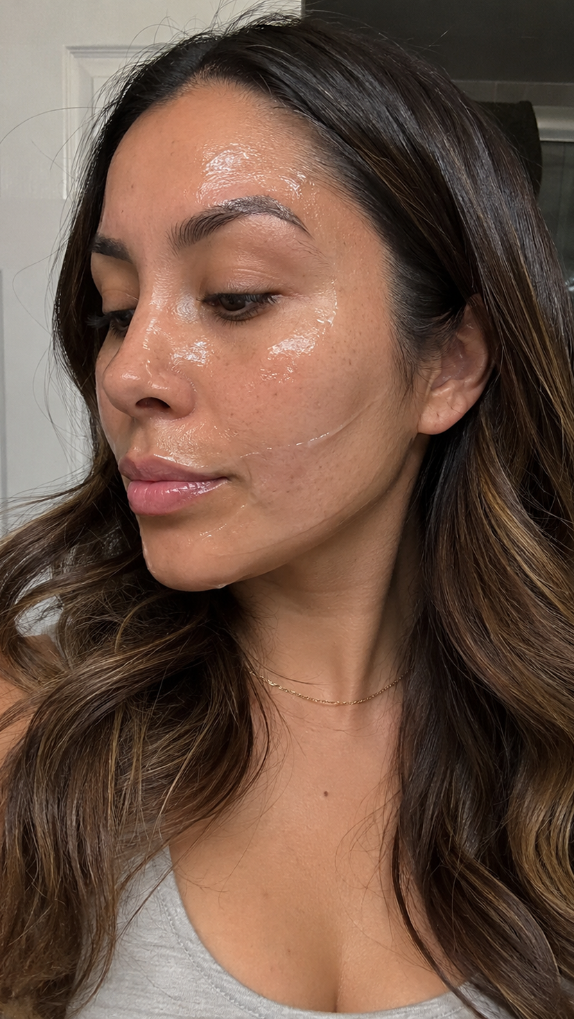 A close-up of a woman's face with a clear, glossy skincare product applied to her skin.