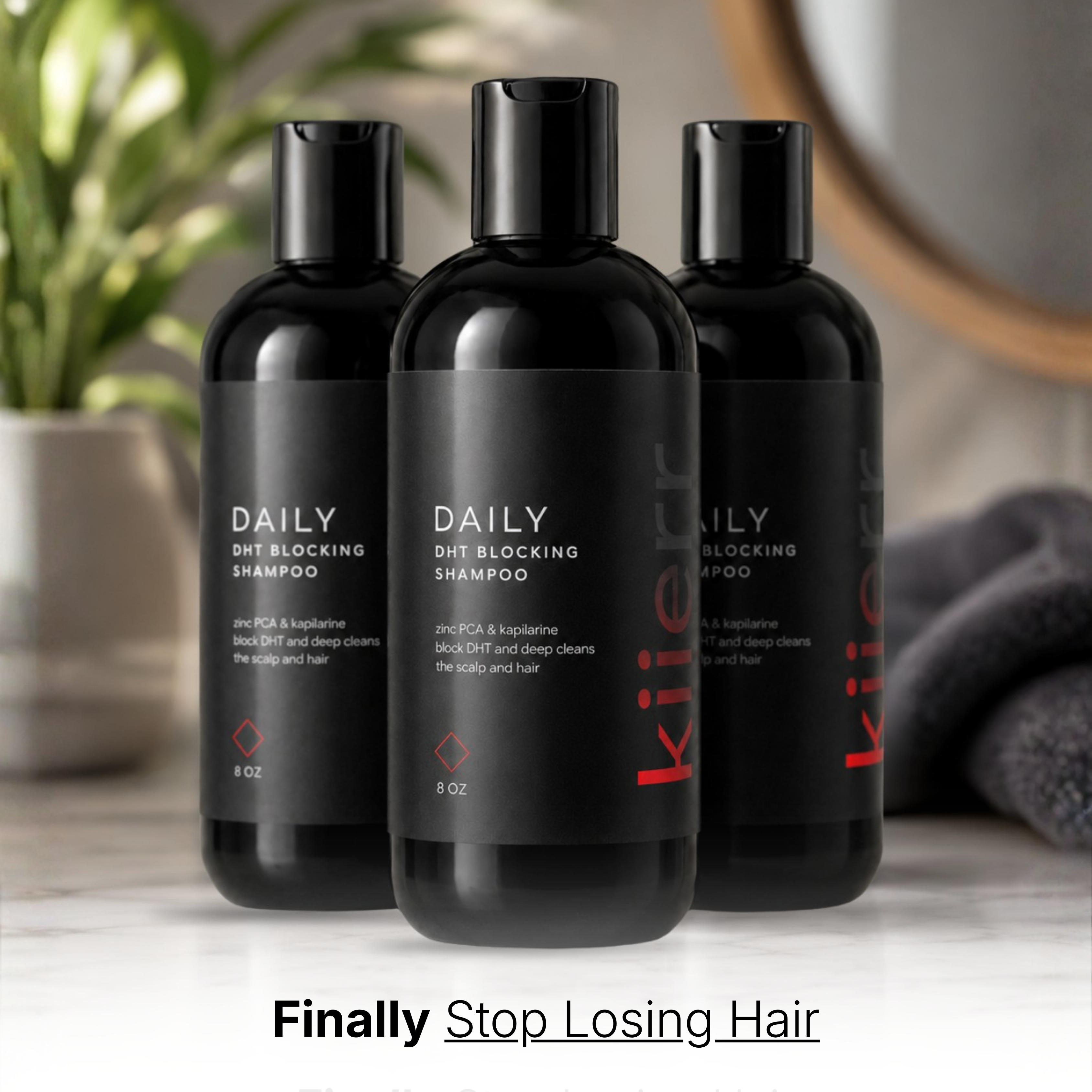 Three black bottles of Daily DHT Blocking Shampoo sitting on a marble countertop in a bathroom setting.