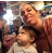 A woman and a child making funny faces in a crowded indoor setting.