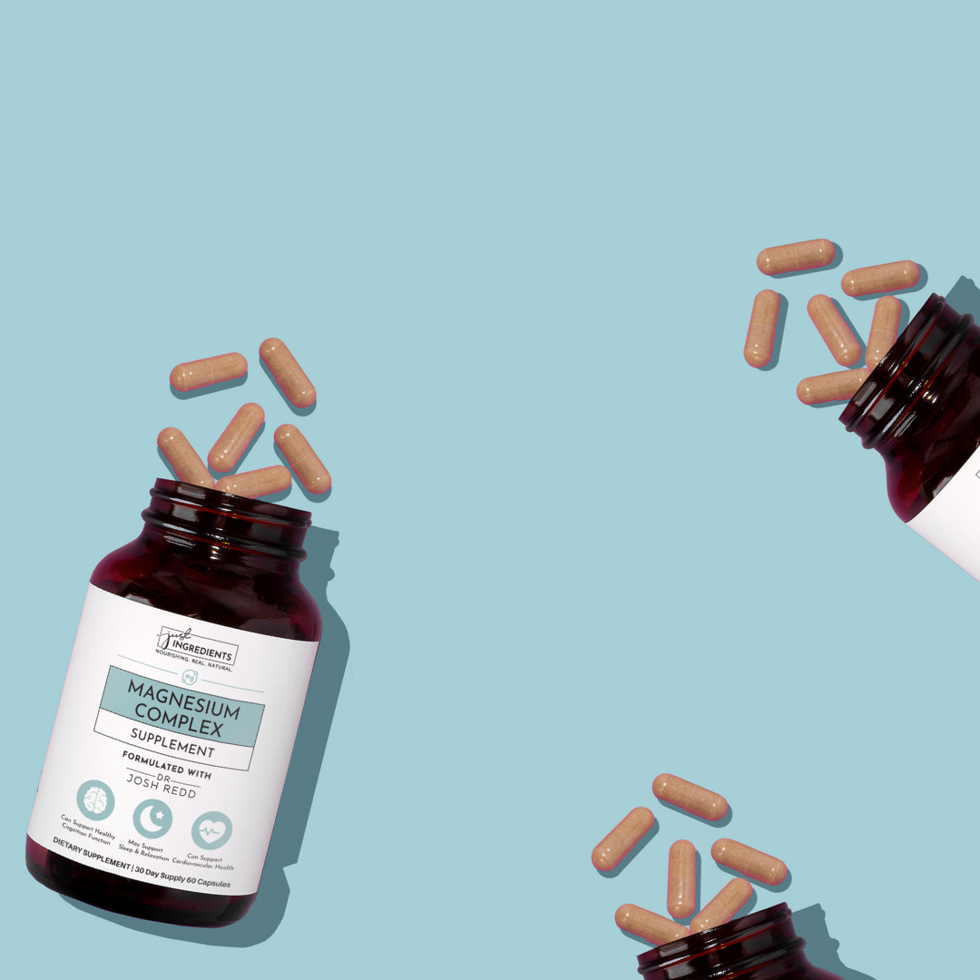Two supplement bottles with capsules spilling out on a blue background.