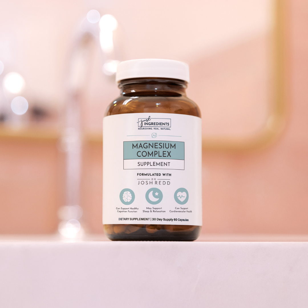 A bottle of magnesium complex supplement on a countertop.