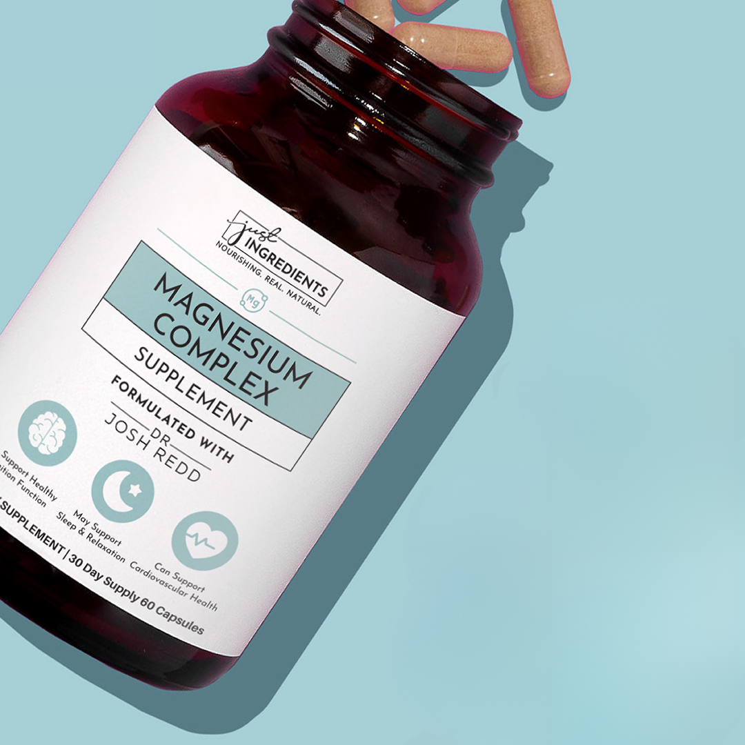 Brown bottle labeled 'Magnesium Complex Supplement' with capsules spilling out.