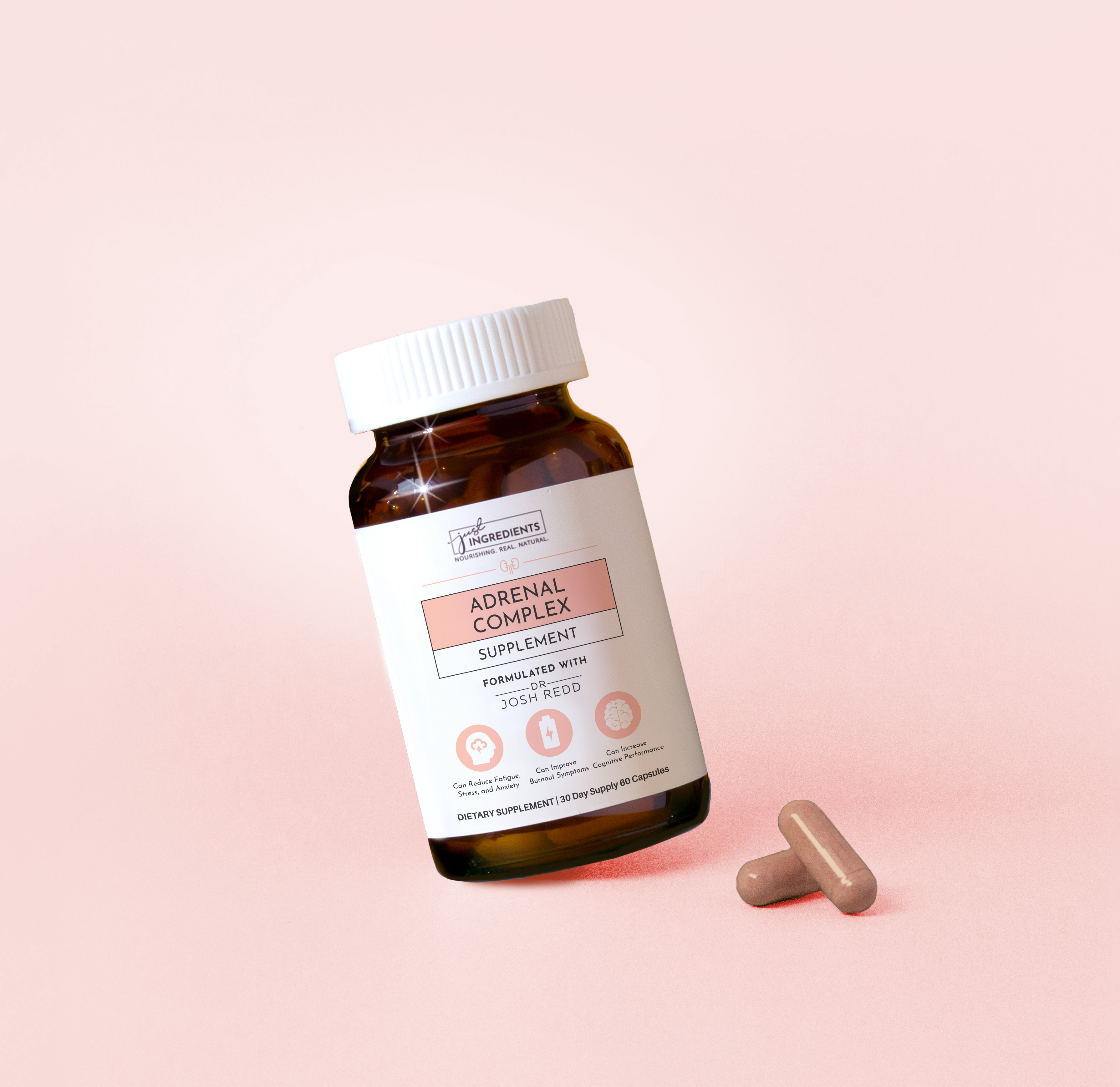 Brown supplement bottle labeled 'Adrenal Complex' with two capsules on a pink background.