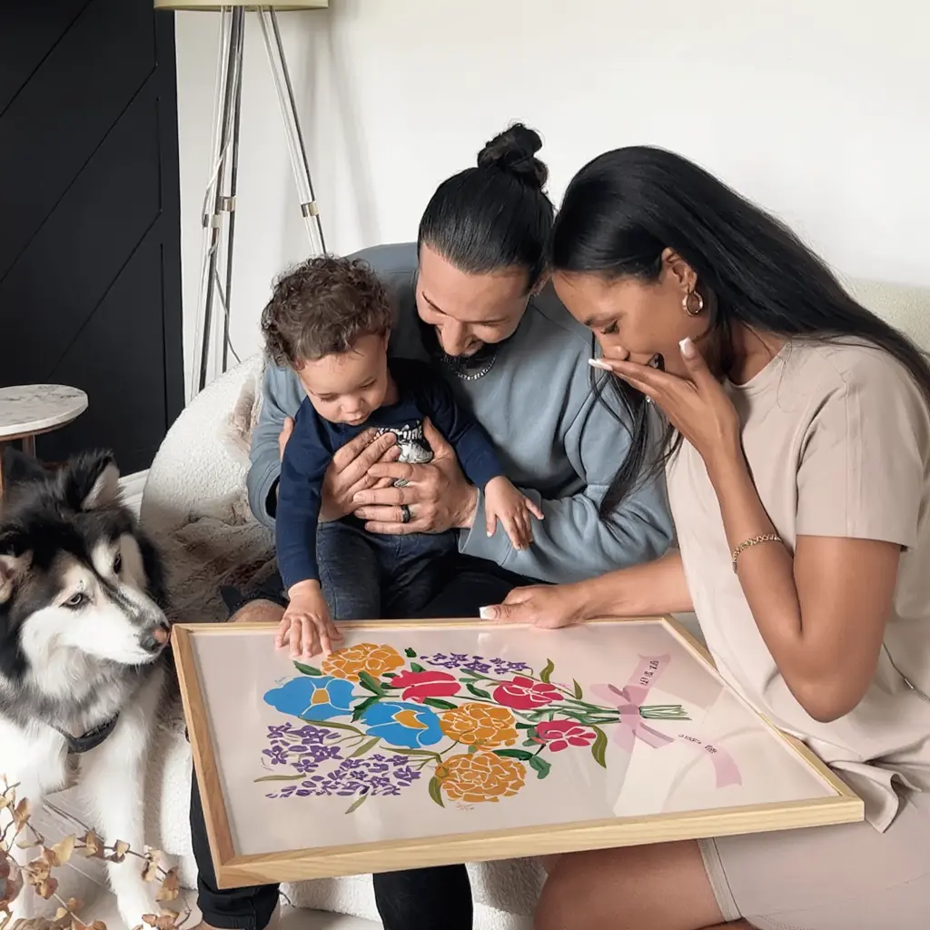 Family with child and dog looking at colorful floral painting.