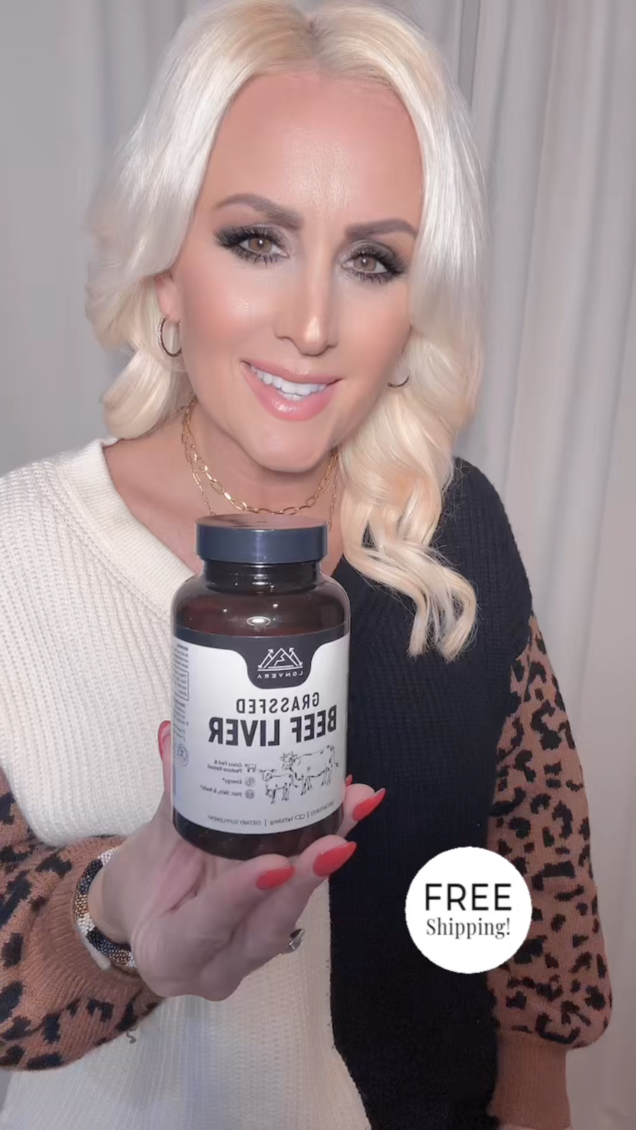 Person holding a bottle labeled 'Grassfed Beef Liver' with 'Free Shipping' text.