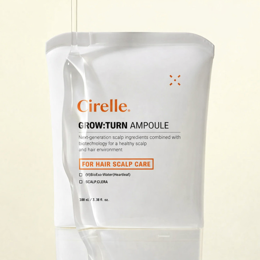 A white tube of Cirelle Grow:Turn Ampoule with a clear liquid dripping onto the side.