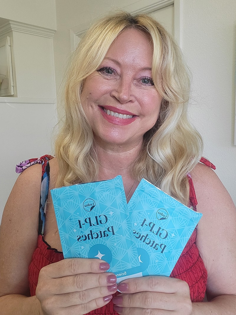 Person holding two blue packets labeled 'C-P-1 Patches.'