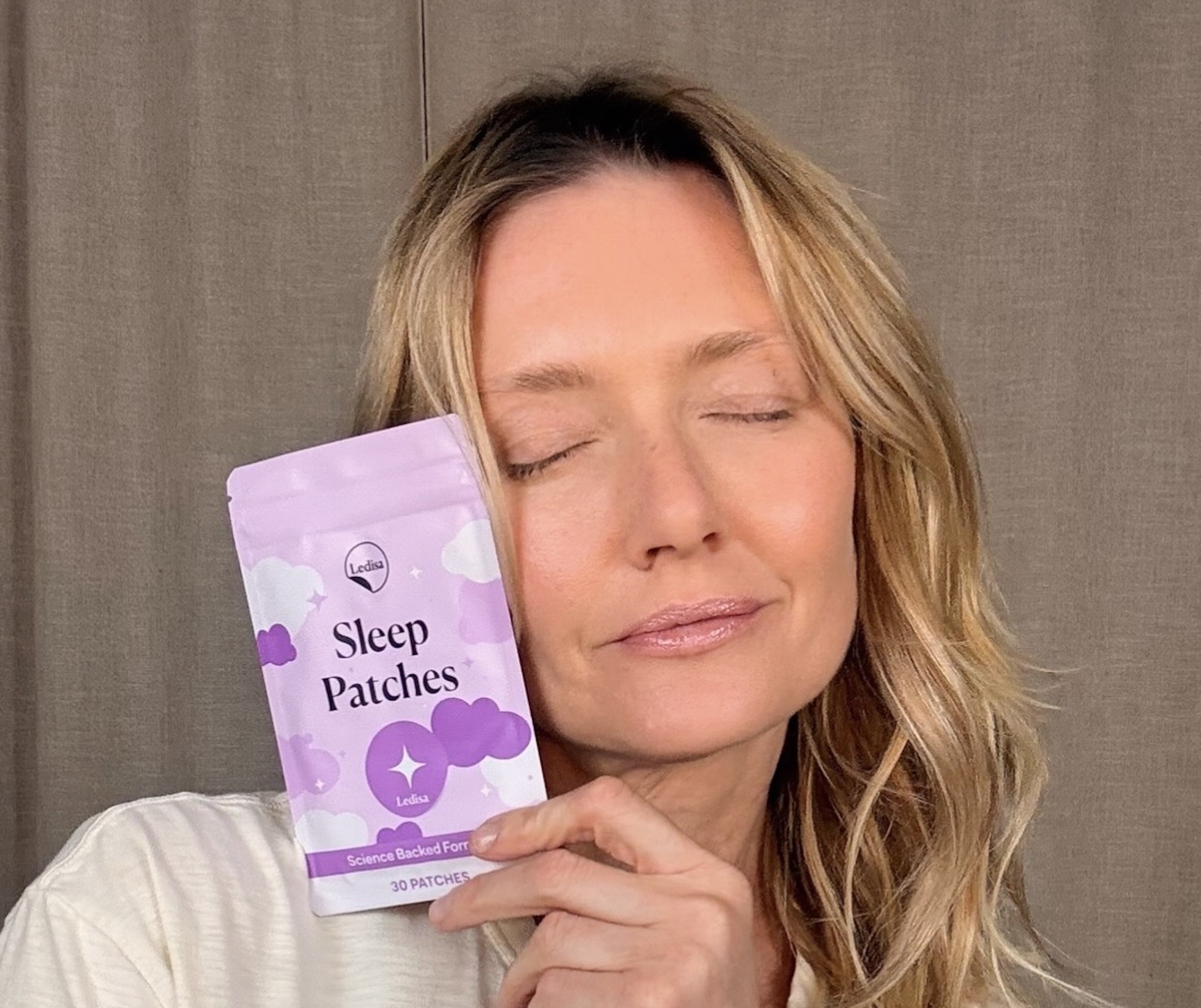 Person holding a package of 'Sleep Patches' with a relaxed expression.