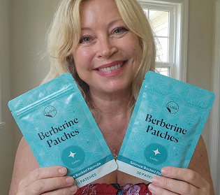 A smiling blonde woman holds up two turquoise packages labeled 'Berberine Patches'.