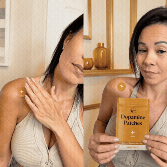 Woman applying and holding package of dopamine patches on shoulder.