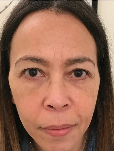 Close-up of a woman looking directly at the camera.