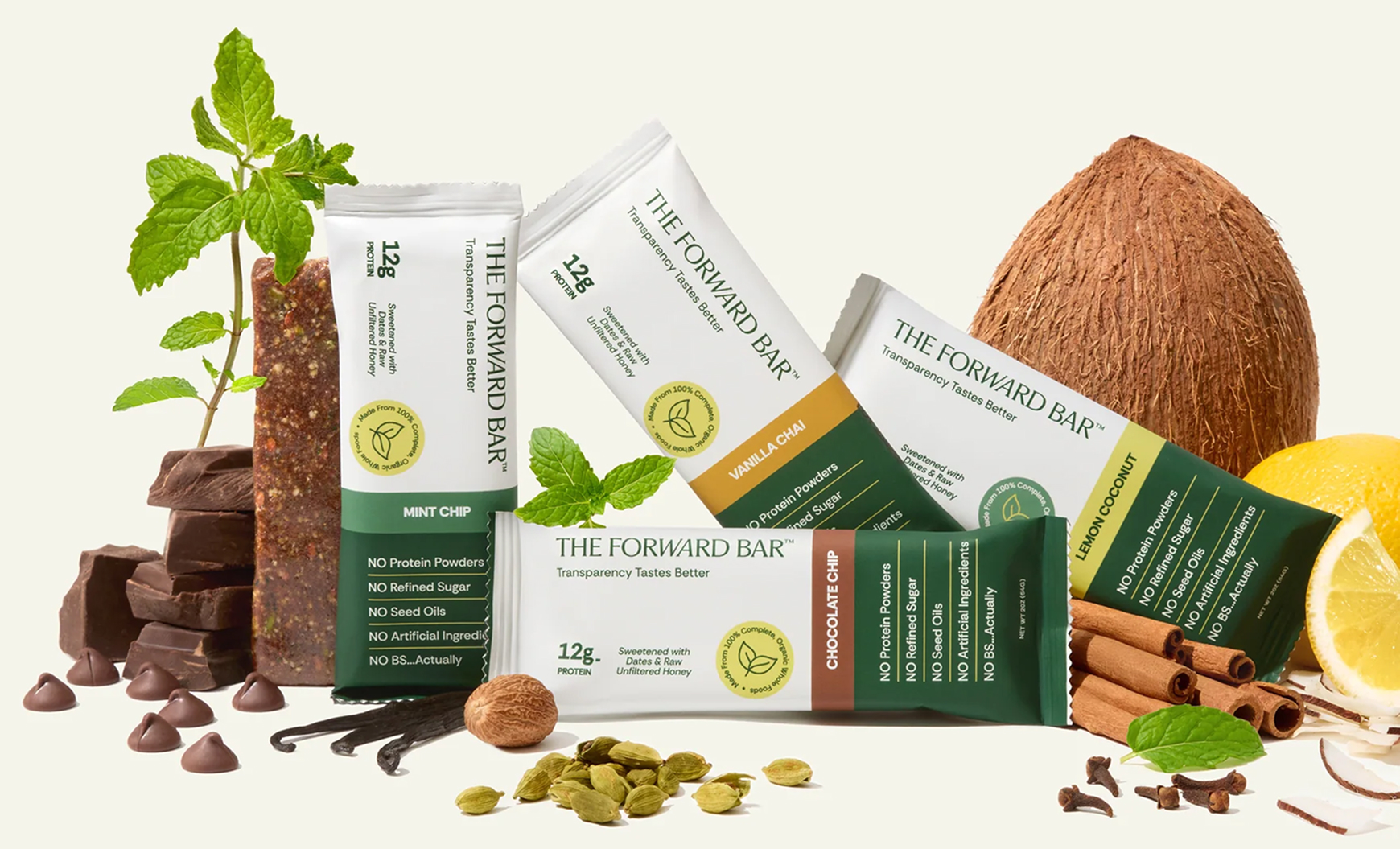 An arrangement of The Forward Bar protein bars with their corresponding fresh ingredients on a white background.