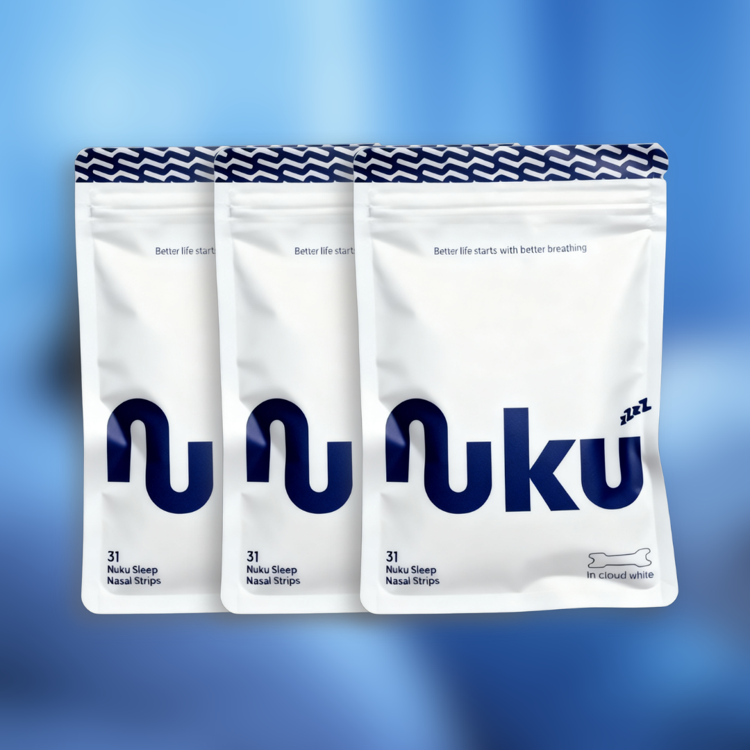 Three white packages of Nuku Sleep Nasal Strips lined up against a blue gradient background.