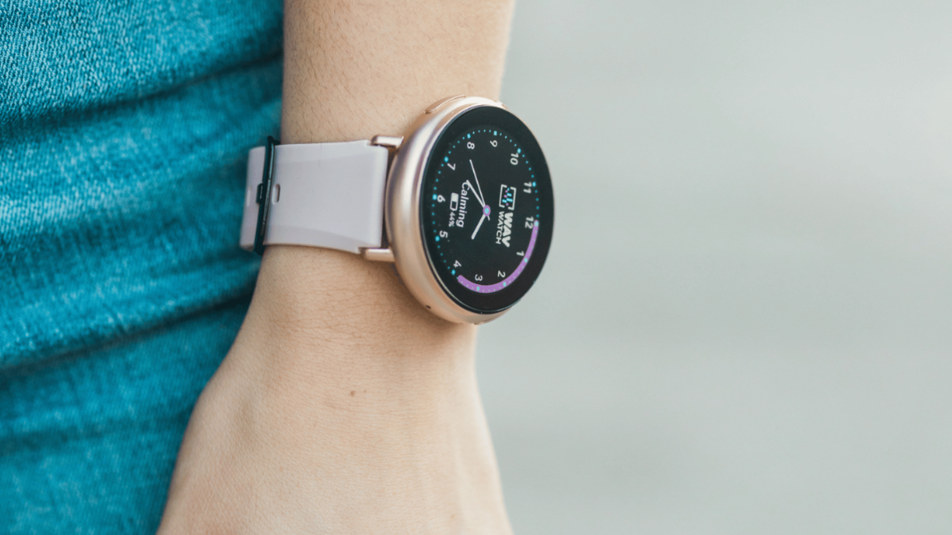 A smartwatch with a white band on a person's wrist.