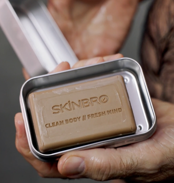 Person holding a soapy bar of soap.