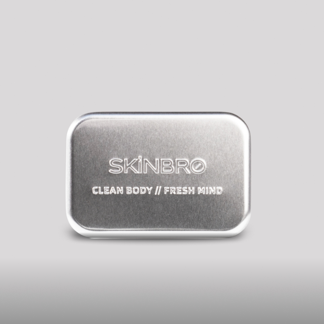 A brushed metal tin with 'SKINBRO' and 'CLEAN BODY // FRESH MIND' embossed on the front.