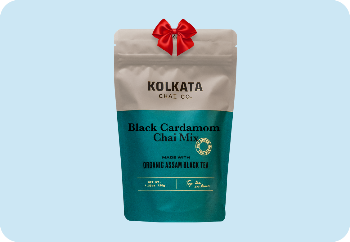 Teal and beige tea package labeled 'Kolkata Chai Co. Black Cardamom Chai Mix' with a red bow.