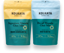 Two pouches of Kolkata Chai Co. chai mix, one Signature Masala and one Decaf Masala.