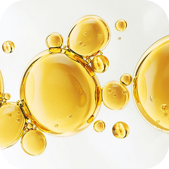 A close-up of glossy, golden bubbles of various sizes against a light background.
